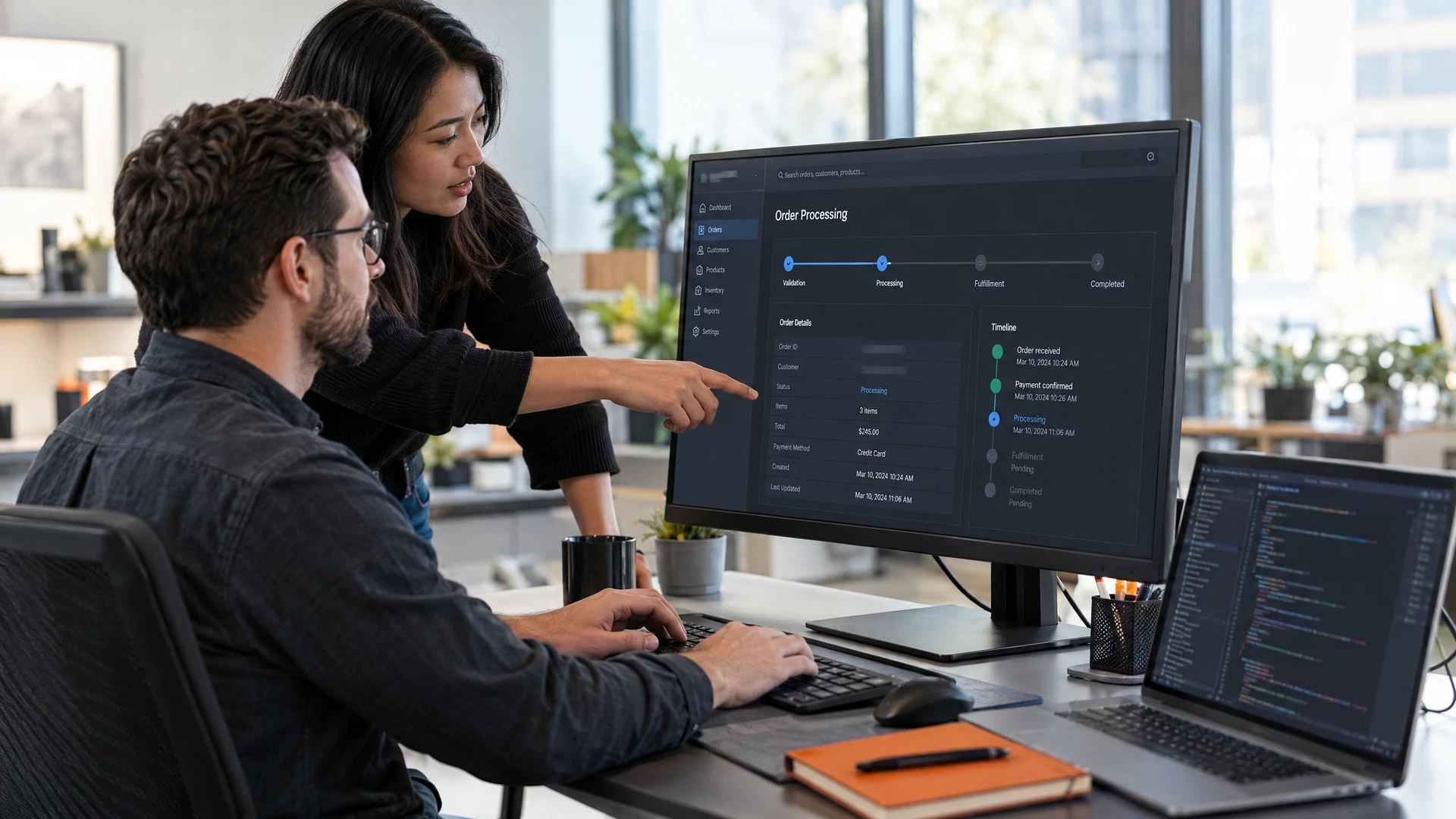 Software engineers collaboratively reviewing an application at a modern workstation